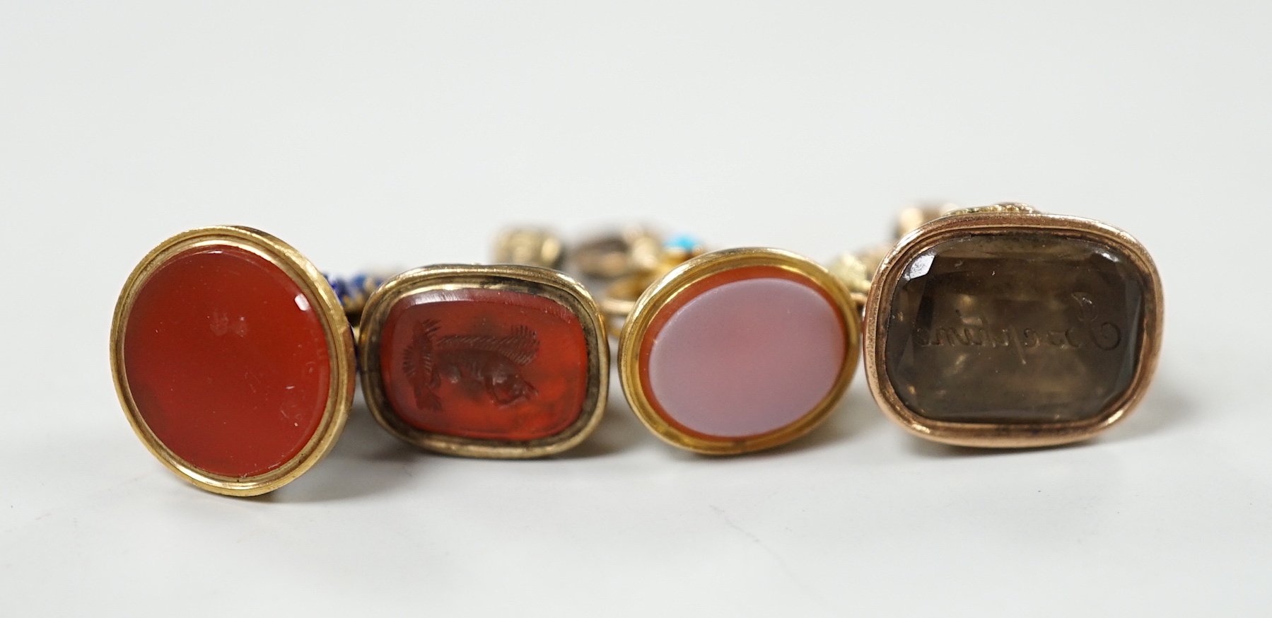 A group of eight assorted 19th century yellow metal overlaid and chalcedony or citrine set fob seals, including two colour, enamelled and turquoise set, largest 20mm.